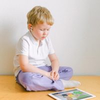 boy-in-white-polo-shirt-sitting-iPad